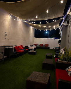 The Canopy 18 patio lit up with string lights at night